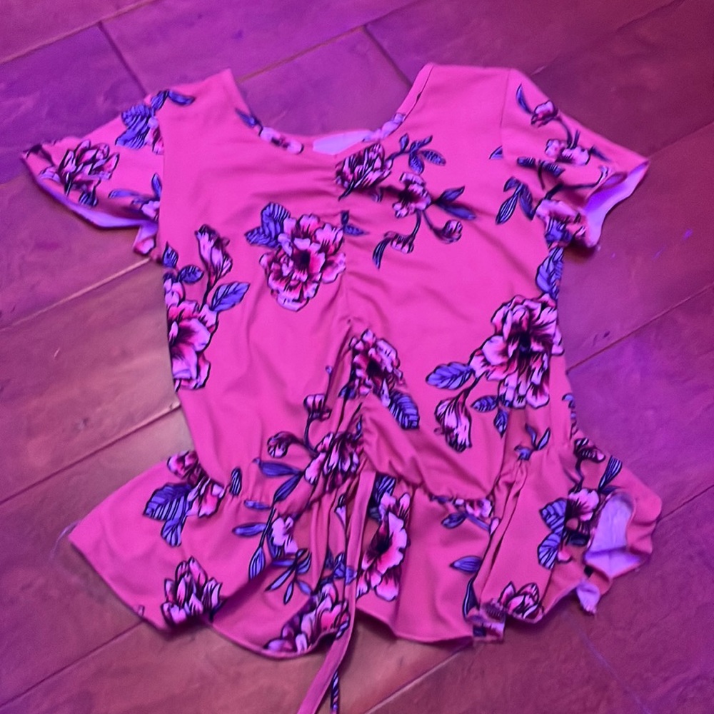 orange ish flower shirt, with tye at the bottom